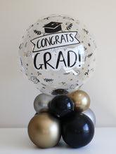 Load image into Gallery viewer, Graduation Bubble Balloon Centerpiece – Congrats Grad Air-Filled Stack (Black, Gold &amp; Silver)
